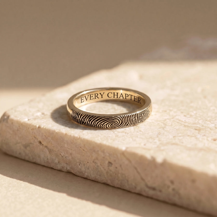 14k Yellow Gold Fingerprint Ring on travertine marble — solid yellow gold, fingerprint wrap, every chapter inside