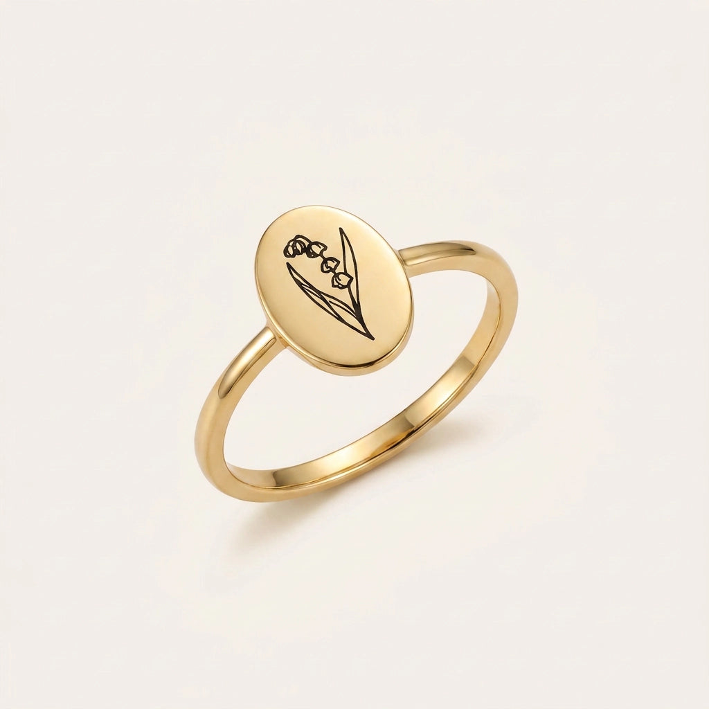 Birth Flower Engraved Ring – Clean studio shot on pearl-white background (oval gold signet, lily of the valley engraving)