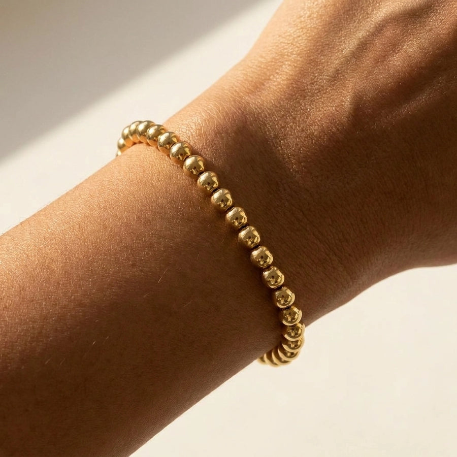 Everyday Dainty Gold Beaded Bracelet — worn olive skin wrist