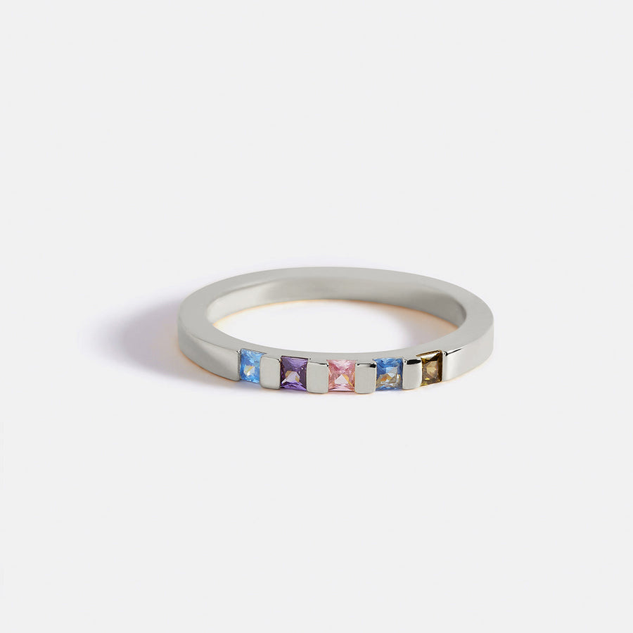 Princess-cut birthstone band ring — silver 3/4 view with colored stones
