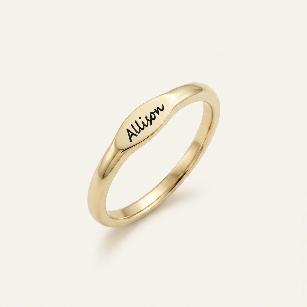 Skinny gold name ring engraved — closeup view