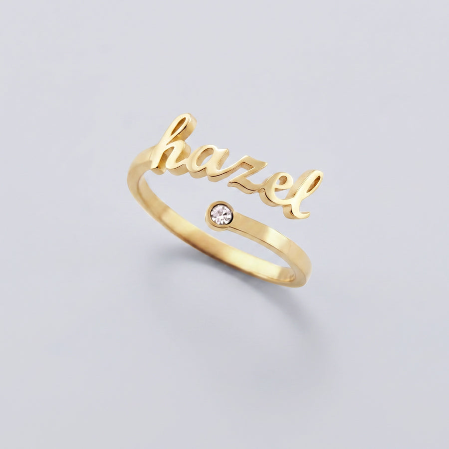 Custom Name Birthstone Ring — gold hazel script with birthstone, hero on gray