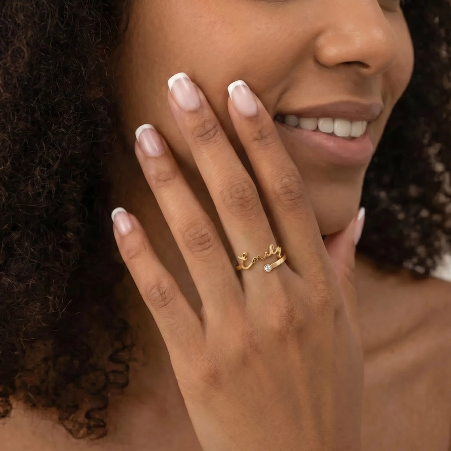 Custom Name Birthstone Ring worn by a woman with curly hair