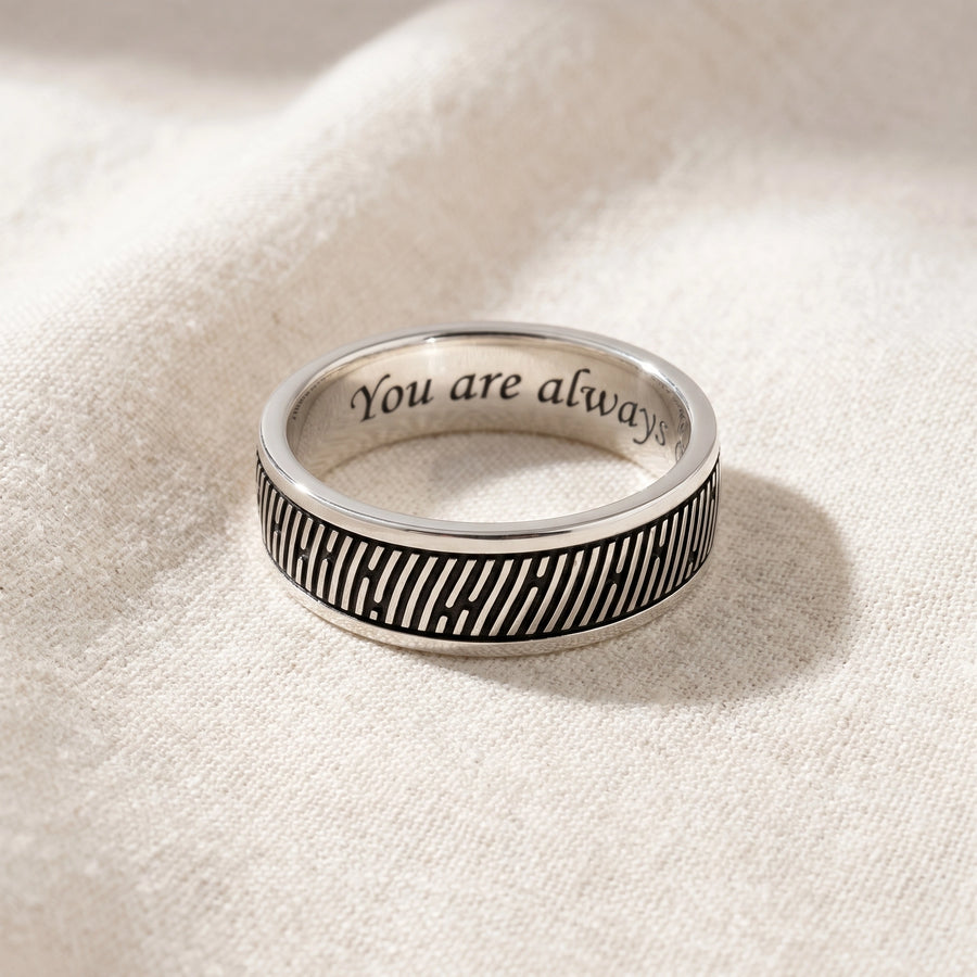 Men's slender sterling silver fingerprint ring on natural linen flatlay