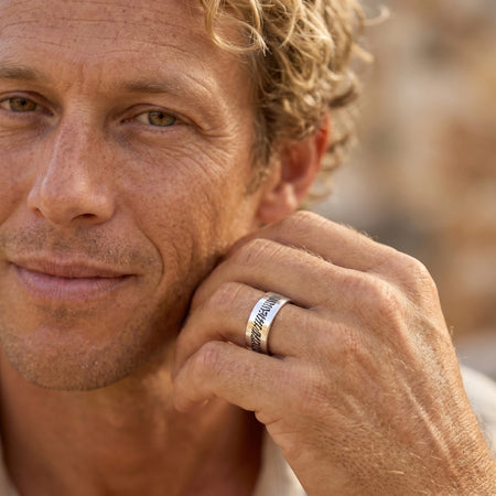 Men's slender sterling silver fingerprint ring worn close-up on a man's hand