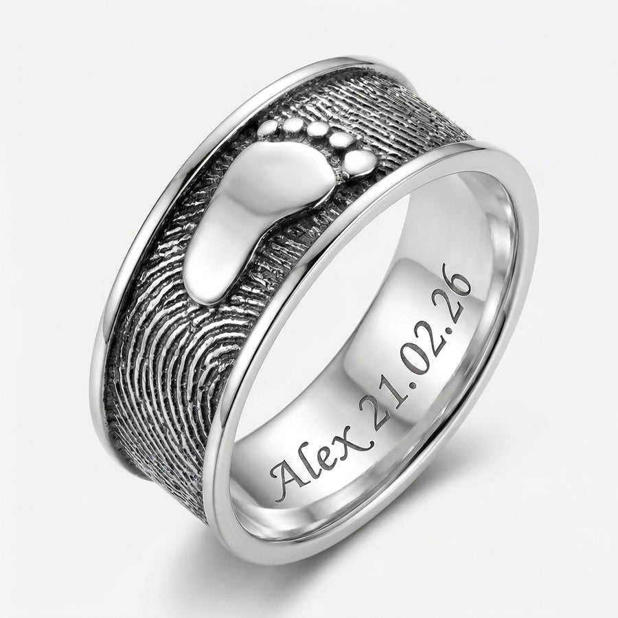 Ring Foot Print Sterling Silver Keepsakes — hero studio shot showing embossed baby footprint and rolled fingerprint pattern with inside engraving Alex 21.02.26