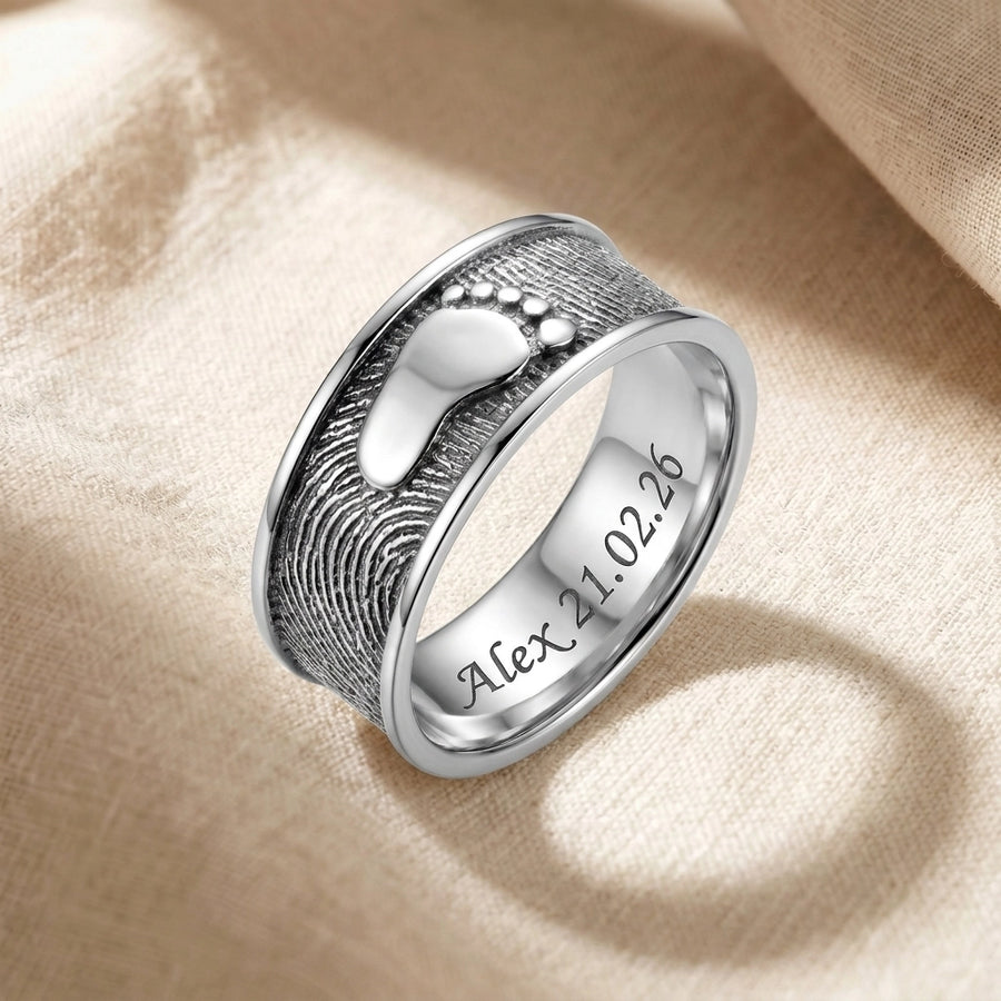 Ring Foot Print Sterling Silver Keepsakes resting on natural ecru linen fabric